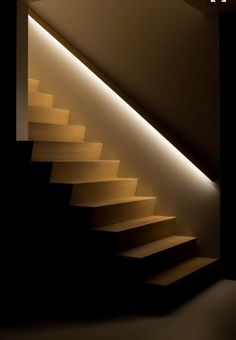 the stairs are lit up and there is only one light in the room to illuminate them