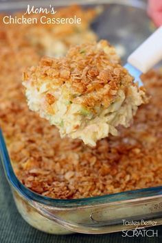 a spoonful of chicken casserole is being lifted from the casserole dish