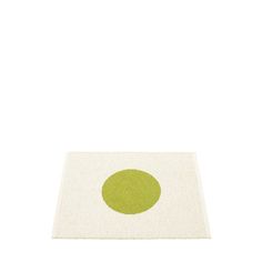 a rug with a green dot on it