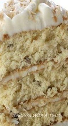 a close up of a slice of cake with white frosting