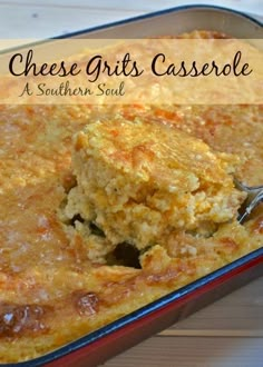 cheese grits casserole in a red baking dish with a spoon scooping out