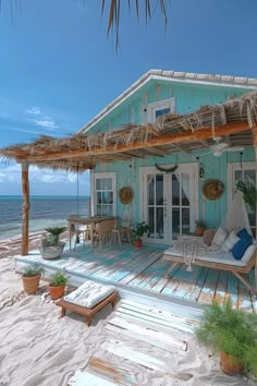 a house on the beach with a hammock and chairs