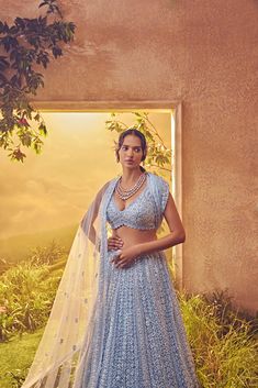 Featuring a sky blue tulle lehenga embroidered fully by hand with various tonal ornamental sequences and tonal Japanese bugle beads. It is paired with a cutwork dupatta and a stylised blouse .From Aneesh Agarwaal's Ellora collection.DELIVERY TIMEPlease allow 8-12 weeks for your outfit to arrive.FABRIC DETAILSNetProfessional cleaning only. Designer Hand Embellished Blue Dupatta, Blue Anarkali Set Hand Embellished, Blue Anarkali Sets With Hand Embellished Details, Blue Hand Embellished Anarkali Set, Hand Embellished Blue Anarkali Set, Traditional Hand Embellished Blue Set, Light Blue Embroidered Choli For Reception, Bollywood Style Hand Embellished Blue Sets, Traditional Hand Embellished Blue Choli