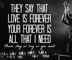 a man standing on top of a stage holding his hands up in the air with a quote above him that says, they say that love is forever