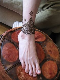 a person's foot with a henna tattoo on their left hand and the words north african patterned henna foot i henna feet and africans and africans