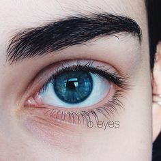 a close up of a person's blue eye