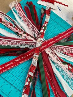 ribbons are laid out on top of a cutting board to make christmas ribbon wreaths