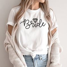 a woman wearing a t - shirt that says bride with a diamond on the front