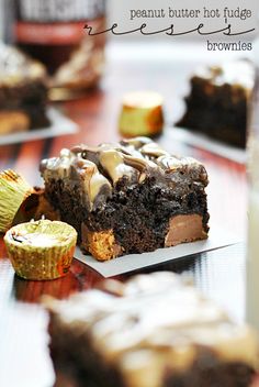 a piece of cake sitting on top of a white plate next to cupcakes