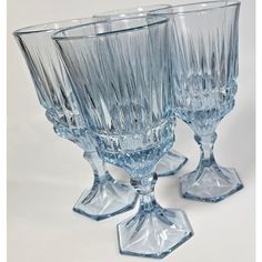 three glass goblets sitting next to each other