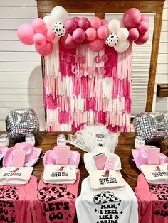 a table set up with pink and white decorations