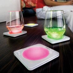 three different colored glasses sitting on top of a table