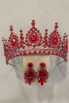 a red tiara with matching earrings on display