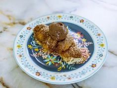 a piece of cake on a plate with chocolate frosting