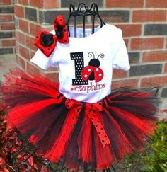 a red and black ladybug birthday tutule outfit with matching hair bow