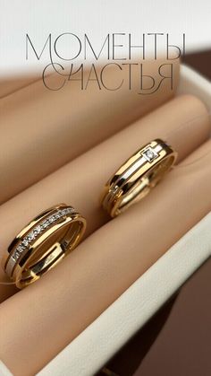 two gold wedding rings sitting on top of each other in a ring box with the words, mom and daughter written above them