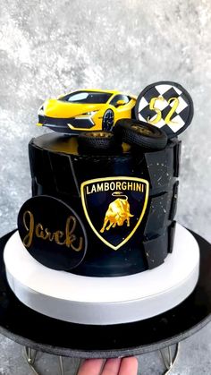 a black and white cake with yellow cars on it