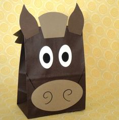 a brown paper bag with a horse's head cut out on it and eyes