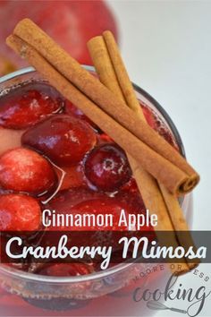 cinnamon apple cranberry mimosa recipe in a glass bowl with cinnamon sticks