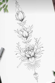 an ink drawing of flowers on paper next to some scissors and pencils, with the title