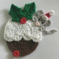 there is a crocheted christmas ornament with a mouse on top of it