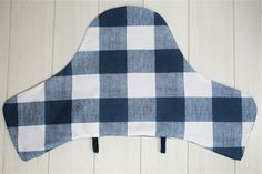 a blue and white gingham checkered oven mitt sitting on top of a wooden floor