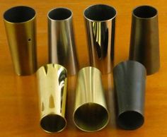 several different types of metal cups on a table