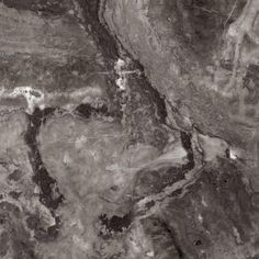 black and white marble textured with dark brown streaks on the top right side, showing an area that looks like it has been split into two separate areas