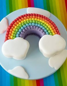 a rainbow themed birthday party with cake and cupcakes