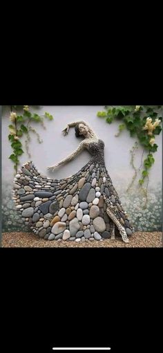 a woman in a long dress made out of rocks