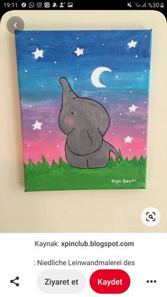 an elephant is sitting in the grass under a night sky