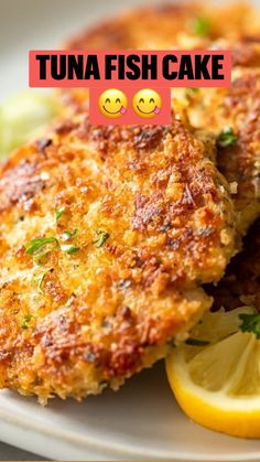 two crab cakes on a plate with lemon wedges