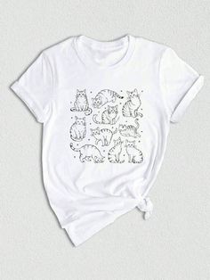 a white t - shirt with cats drawn on it