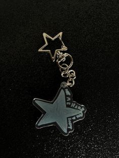 a key chain with a star on it sitting on top of a black countertop