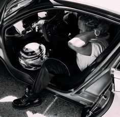 a man sitting in the driver's seat of a car