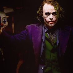 the joker is holding his hands up