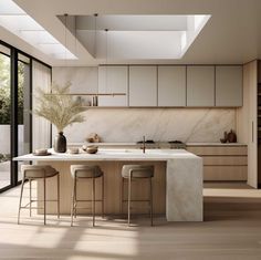 a modern kitchen with marble counter tops and stools next to an open floor plan