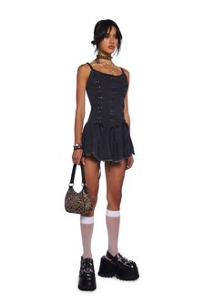 This mini dress has a washed denim construction, adjustable shoulder straps, back zipper closure, distress trim, and front lace up designs with ties. Black Casual Corset Dress For Spring, Edgy Sleeveless Corset Dress, Gothic Black Mini Dress With Straps, Casual Black Corset Dress, Spring Black Corset Dress With Lace-up Back, Black Mini Corset Dress With Lace-up Back, Edgy Sleeveless Corset Dress For Alternative Fashion, Gothic Summer Mini Dress With Corset Back, Gothic Mini Dress With Corset Back For Summer