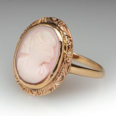 This elegant antique ring features a shell cameo and is crafted of 14k yellow gold. This ring is currently a size 9.75. The cameo shows heavy wear. Vintage 14k Gold Cameo Rings, Vintage Cameo Rings For Wedding, Vintage Yellow Gold Cameo Rings, Vintage Cameo Engraved Ring For Formal Occasions, Wedding Cameo Ring In Yellow Gold, Vintage Formal Cameo Engraved Ring, Art Deco Oval Cameo Rings, Elegant Wedding Cameo Signet Ring, Wedding Yellow Gold Cameo Ring