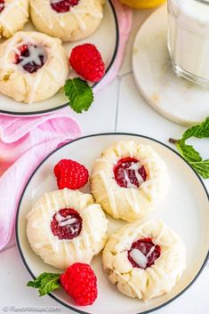 raspberry lemon shortbreads on white plates with glass of milk