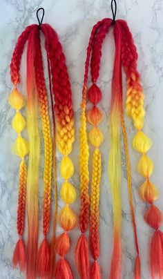 Light a fire as you strut your sultry locks. Reds, Oranges, and Yellows for a firey look. 5 Strand Braids, 7 (Yes, 7!) Strand Braids, Bubble Braids, and Fishtail Braids...just in case you couldn't decide which styles you liked the best, we got you covered with this big variety 😉😉On a hair tie for easy use. Wrap the loose hair section around a ponytail or bun and secure with a bobby-pin, or braid it into your own hair for awesome and easy festival braids. Sold as a set of 2 pigtails. Natural Curly Hair Blonde, Curly Hair Blonde Balayage, Fire Wig, Yellow Hair Color Ideas, 2 Pigtails, Hair Streamer, 5 Strand Braids, Braids Extensions, French Fishtail