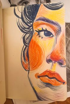 a drawing of a man's face with orange and blue colors on paper next to other drawings