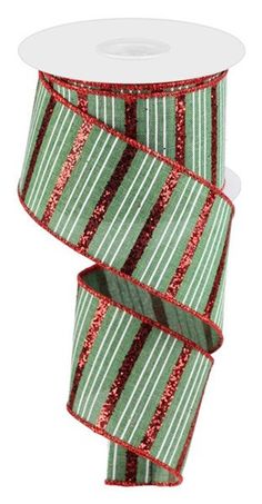 a roll of green and red glitter ribbon with stripes on the side, in front of a white background