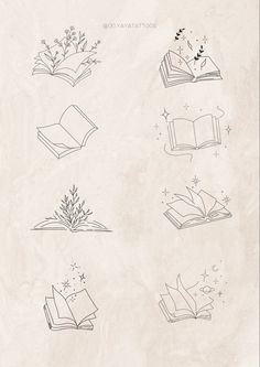 an open book sitting on top of a table next to flowers and stars in the sky