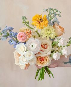 a person holding a bouquet of flowers in their hand