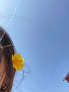 a girl with a yellow flower in her hair