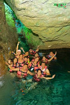 a group of people in life vests posing for a photo