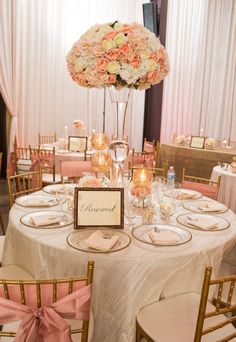 the table is set with pink and white flowers