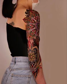 a woman with tattoos on her arm and shoulder