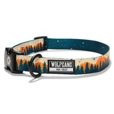 an orange and blue dog collar with trees on it, the collar has a black metal buckle